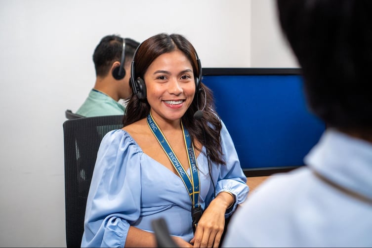 A Select VoiceCom female call center agent in action in the Philippine call center office.