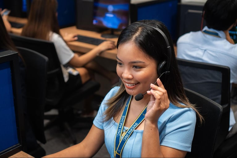 A female customer service representative from Select VoiceCom during her shift in a Philippine call center office.
