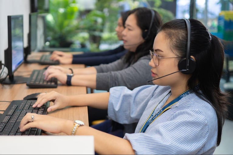 A group of female Select VoiceCom call centre agents during work hours in a Philippine call centre office. 