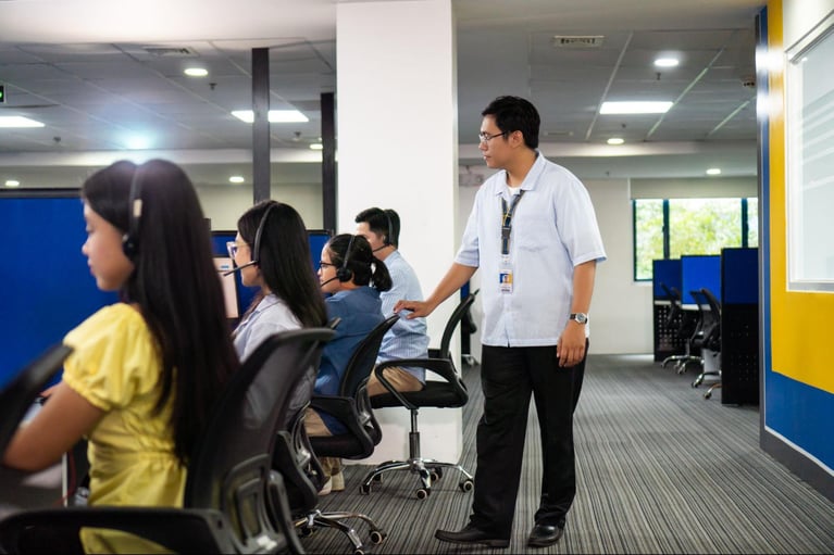 A group of call center agents from Select VoiceCom during work hours inside a Philippine call center office.