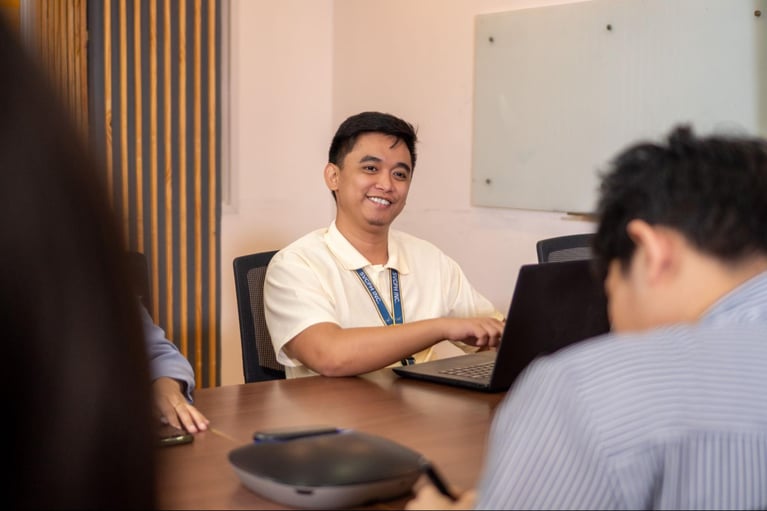 A group of Select VoiceCom employees working in a Philippine call centre office.