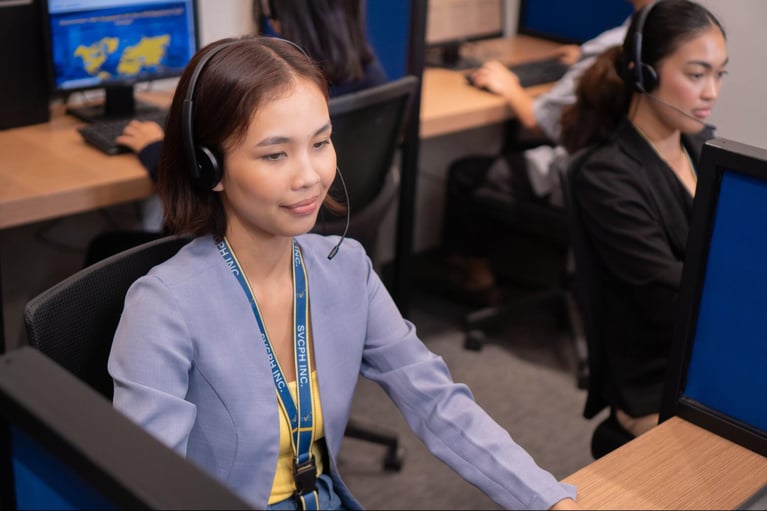 A group of call center agents from Select VoiceCom taking customer calls in the Philippine call center office.