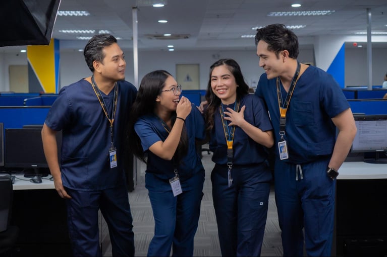 A group of Select VoiceCom call center agents, who are also registered nurses, in a group discussion during their shift at a Philippine call center office.