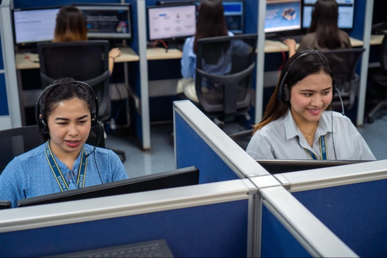 A group of female call centre agents from Select VoiceCom working in the Philippine call centre office.
