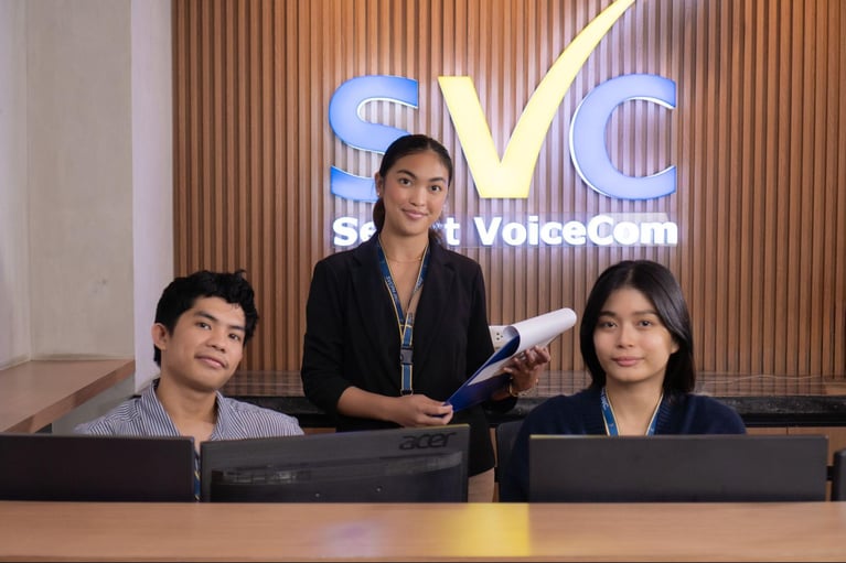 A group of Select Voicecom employees working in a Philippine call centre office.