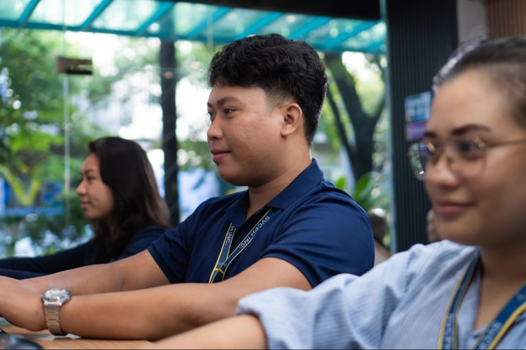 A group of call centre agents from Select VoiceCom during work hours inside a Philippine call centre office.