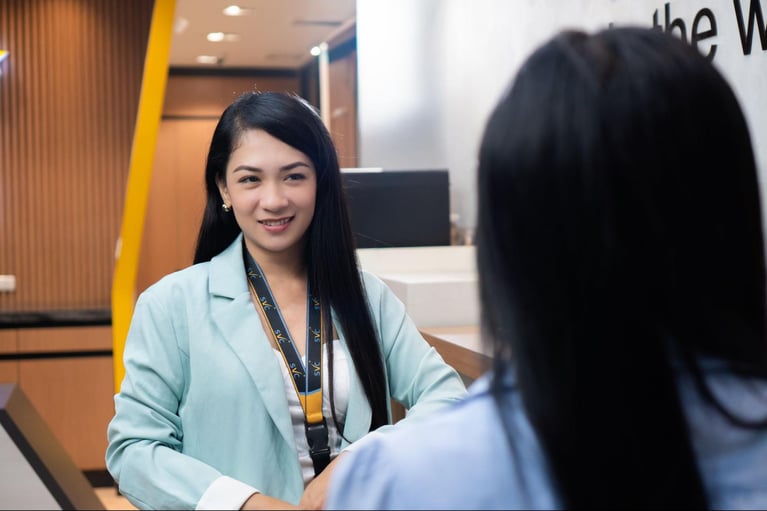 Two female call center agents from Select VoiceCom having a conversation inside a Philippine call center office.