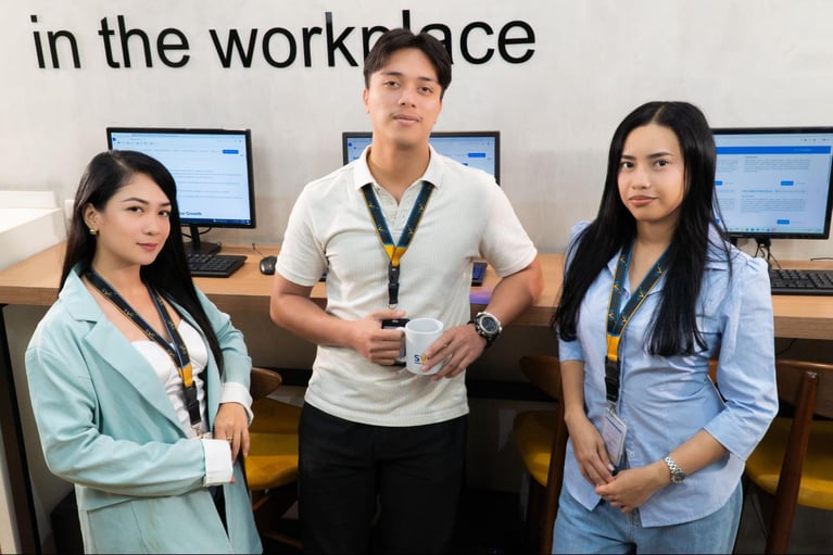 A group of call centre agents from Select VoiceCom in a frame inside a Philippine call centre office.