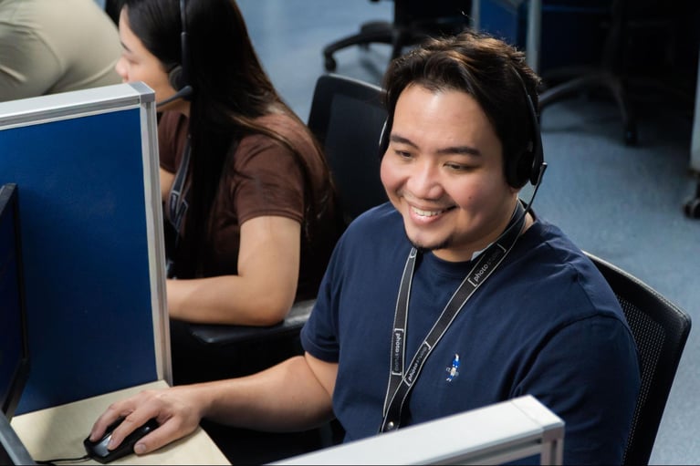A group of call centre agents from Select VoiceCom during work hours inside a Philippine call centre office.