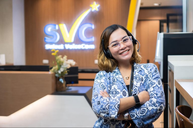 A female call centre agent from Select VoiceCom pose for a photo op  inside a Philippine call centre office.