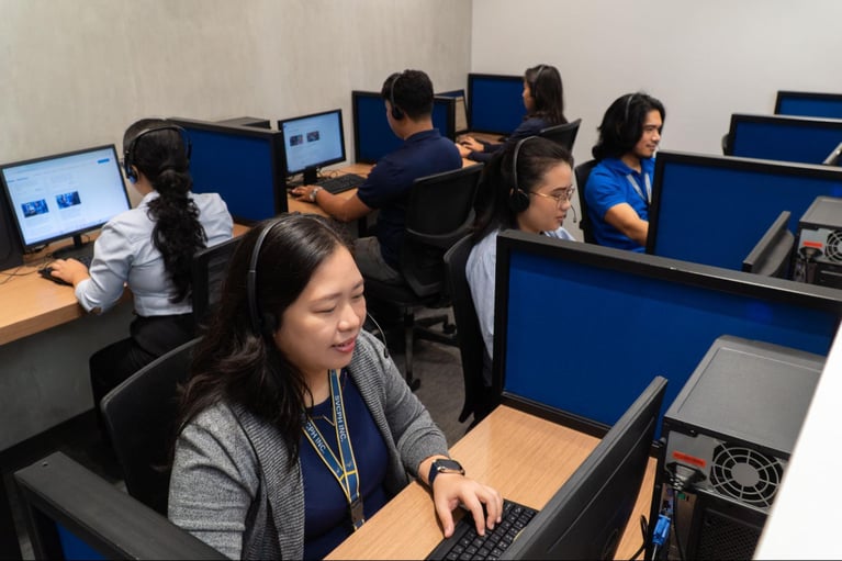 A group of call centre agents from Select VoiceCom in a frame inside a Philippine call centre office.