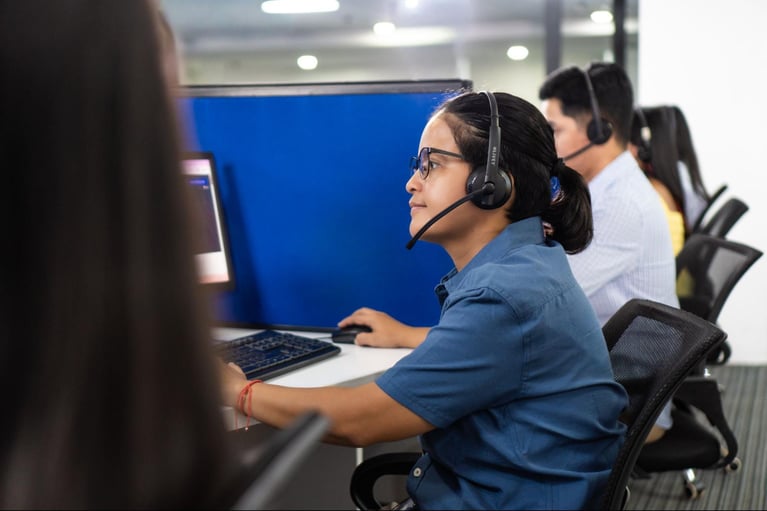 A group of call centre agents from Select VoiceCom during work hours inside a Philippine call center office.