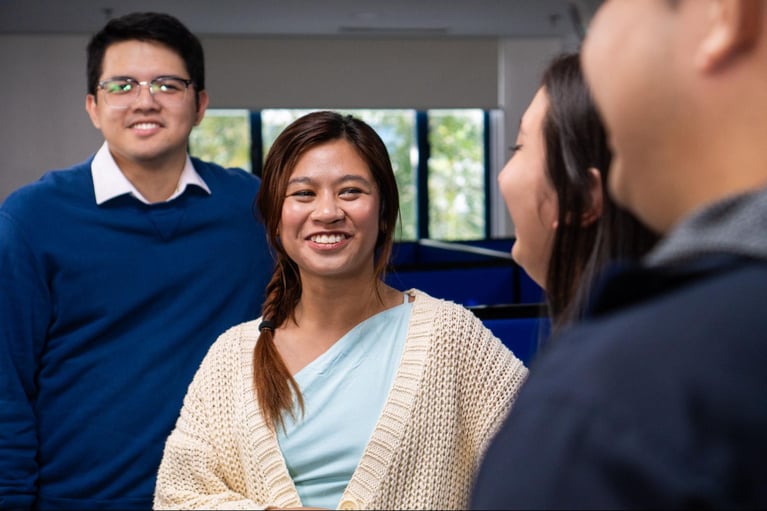 A group of call centre agents from Select VoiceCom in a frame inside a Philippine call centre office.