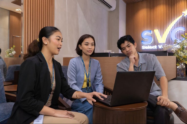 A group of Select VoiceCom staff having a discussion in a Philippines call center office.