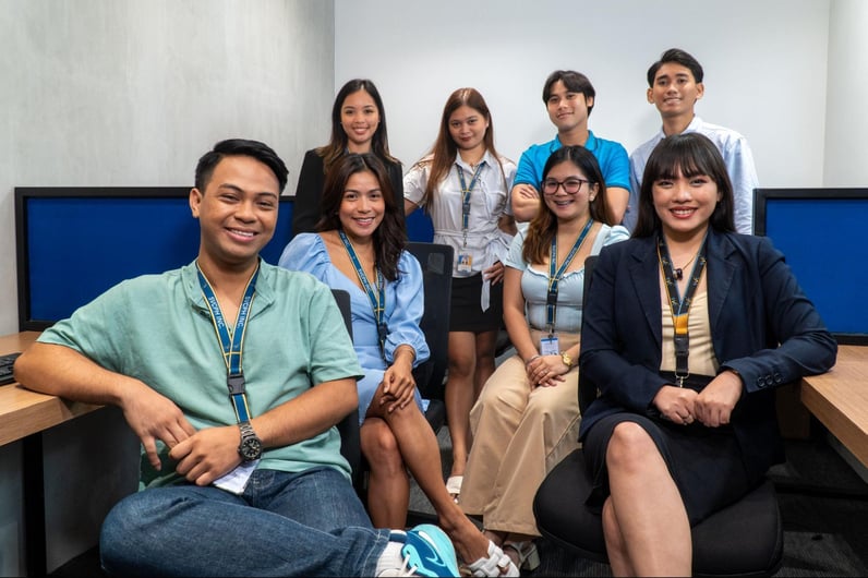 A group of customer service representatives from Select VoiceCom pose for a photo op in their workstation.