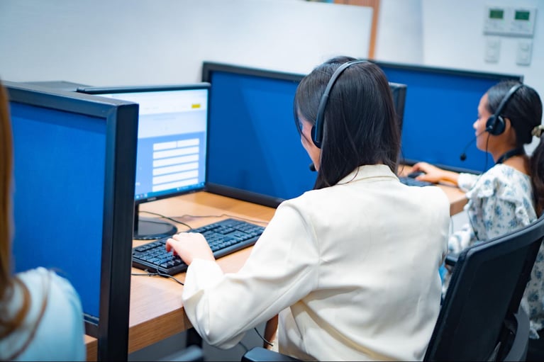 A group of call center agents from Select VoiceCom taking customer calls in the Philippine call center office.