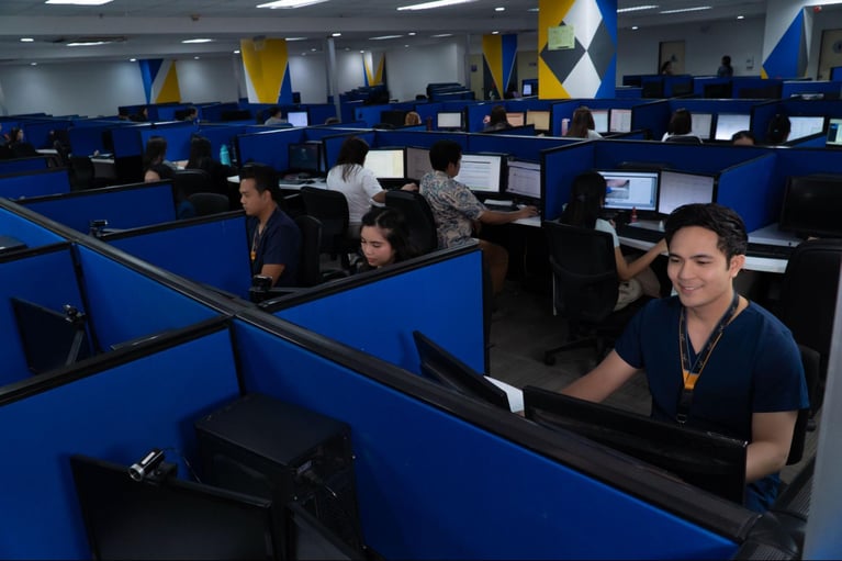A group of call centre agents/nurses from Select VoiceCom during work hours  inside a Philippine call centre office.