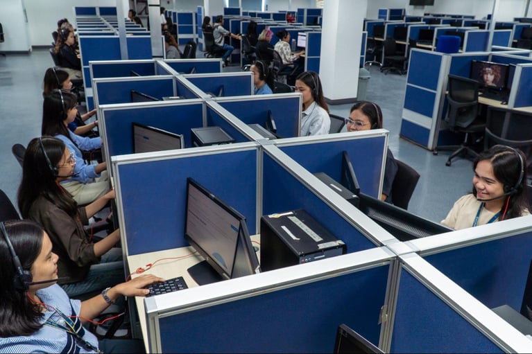 A group of female call centre agents from Select VoiceCom during working hours in a Philippine call centre office.