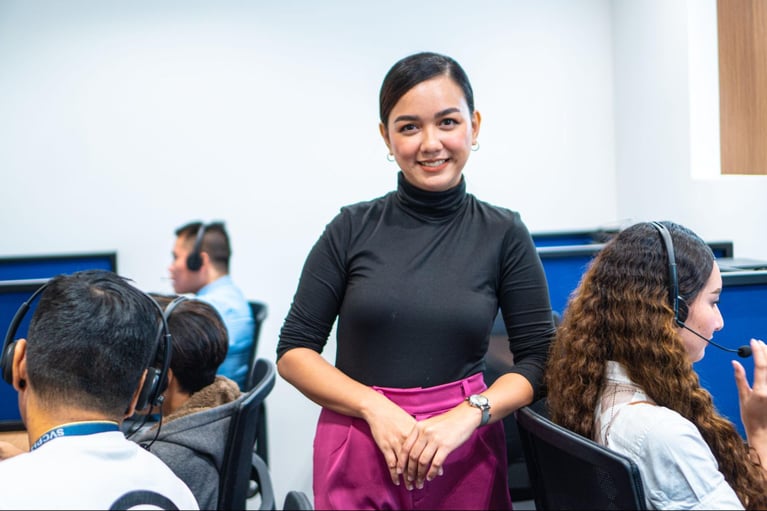 A group of female Select VoiceCom employees taking customer calls in a Philippine call centre office.