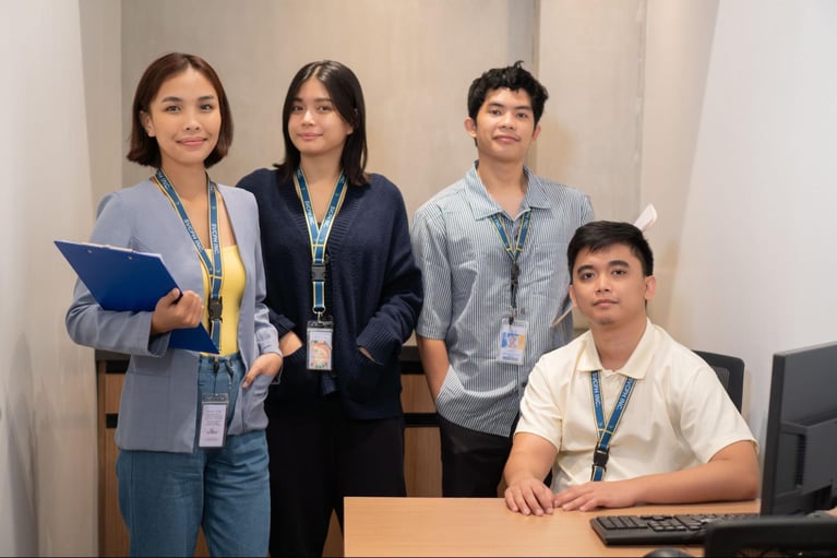 A group of Select VoiceCom employees pose for a photo op in a Philippine call center office.