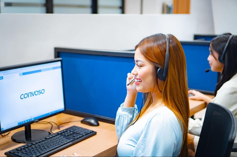 A Select VoiceCom female call center agent answering a customer query in the Philippine call center office.