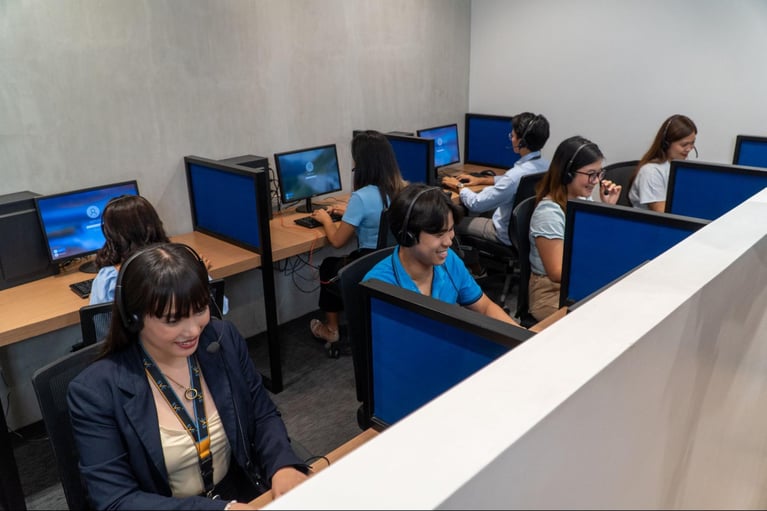 A group of call center agents from Select VoiceCom working in the office.