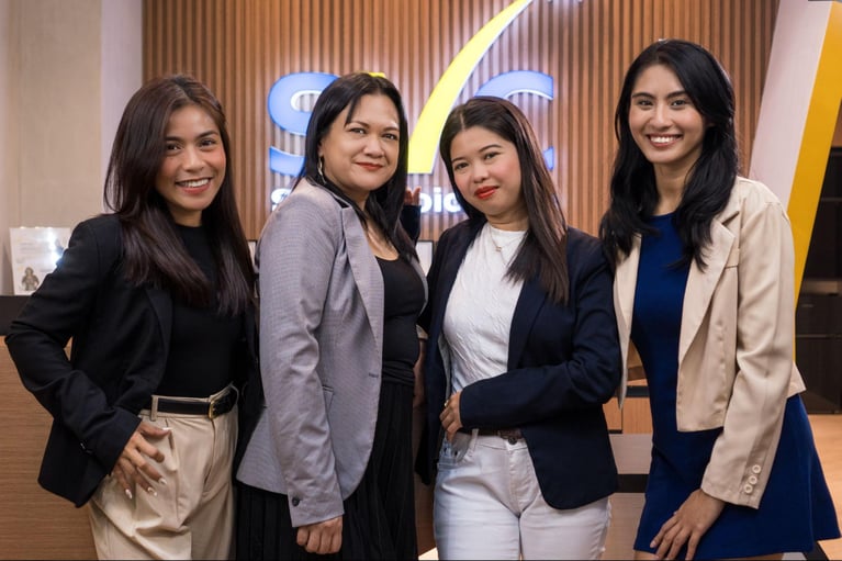 Four female call center agents pose for a photo op inside Select VoiceCom's office.