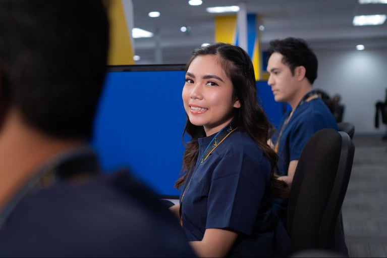 A group of call centre agents (nurses and PTs) from Select VoiceCom during a photo op inside a Philippine call centre office.