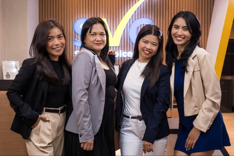 A group of female call centre employees from Select VoiceCom in a frame inside a Philippine call centre office.