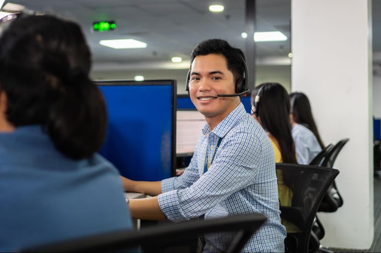 A group of call centre agents from Select VoiceCom during work hours inside a Philippine call centre office.
