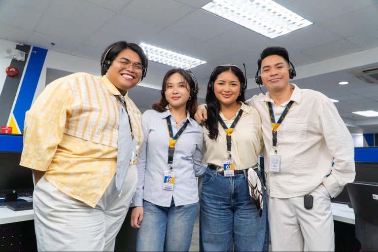 A group of call center agents from Select VoiceCom pose for a photo op inside a Philippine call center office.
